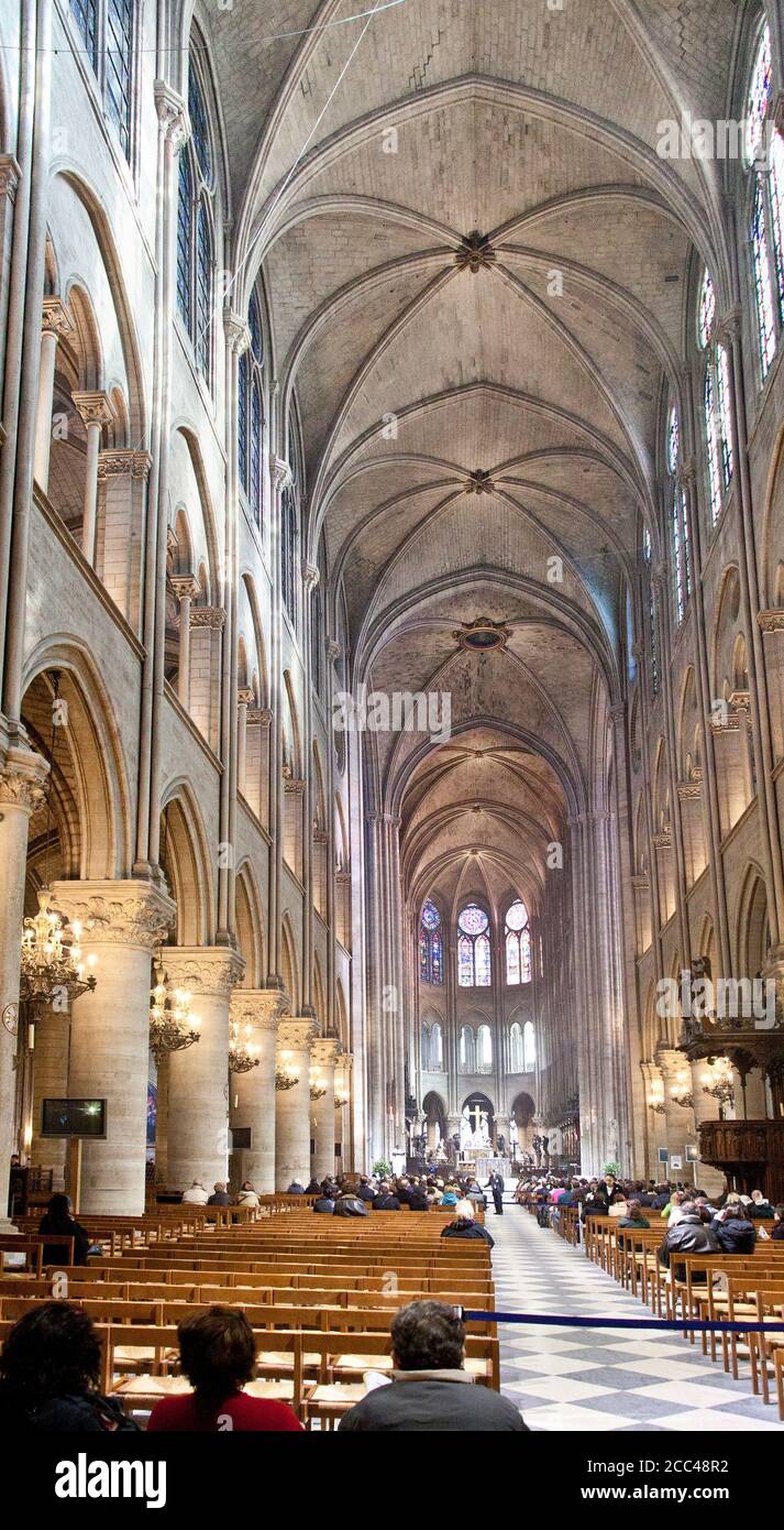 Interior of Notre-Dame de Paris. Notre-Dame de Paris ('Our Lady of Paris'), referred to simply as Notre-Dame, is a medieval Catholic cathedral on the Stock Photo