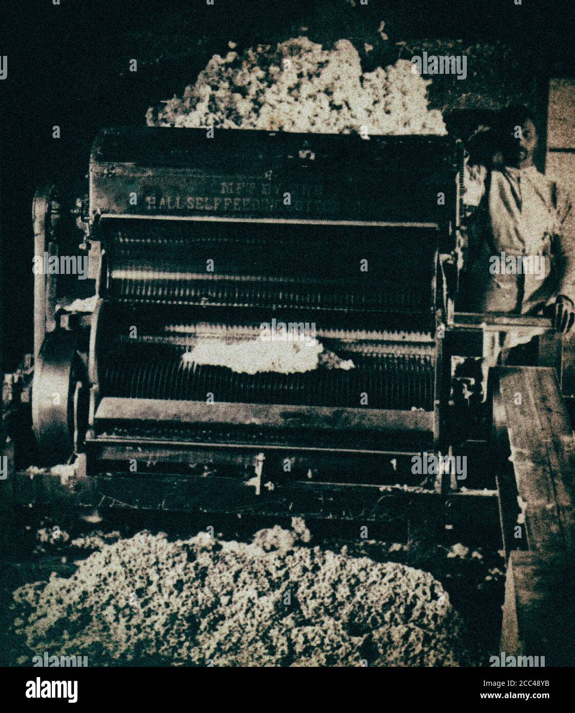 Man in front of a machine to shell cotton. USA. 1890 Stock Photo