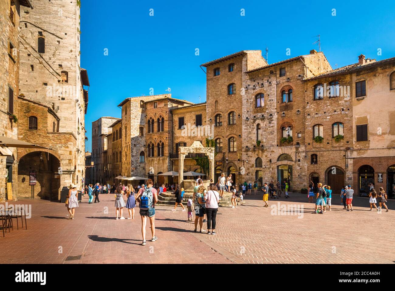 Gorgeous view of the Piazza della Cisterna, main square of San Gimignano in Tuscany. Named after the underground cistern, capped by an octagonal... Stock Photo