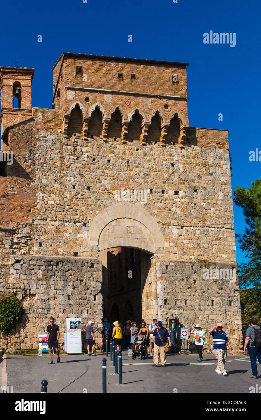 Nice close view of the Porta San Giovanni, where tourists entering and leaving the walled medieval hill town San Gimignano in Tuscany, Italy. The gate... Stock Photo