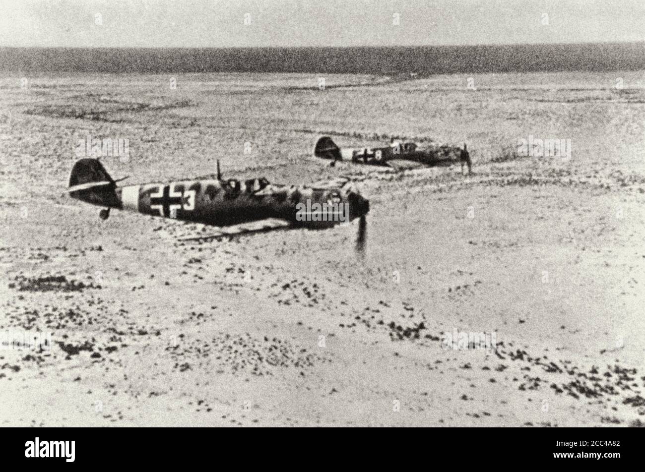The Messerschmitt Bf.109E Luftwaffe fighters from 1.JG27 (W3 +) Sqoadron in flight over North Africa. El Ghazala, Libya. February 1942 Stock Photo