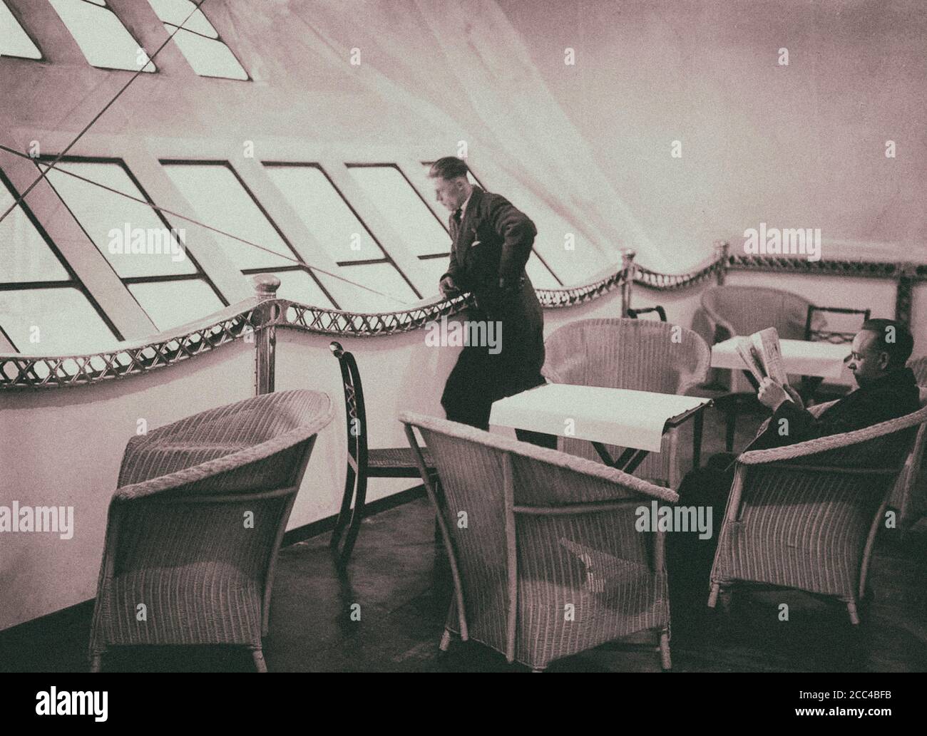 A passenger looking outside the His Majesty's Airship R100 panoramic windows. 1930 Stock Photo