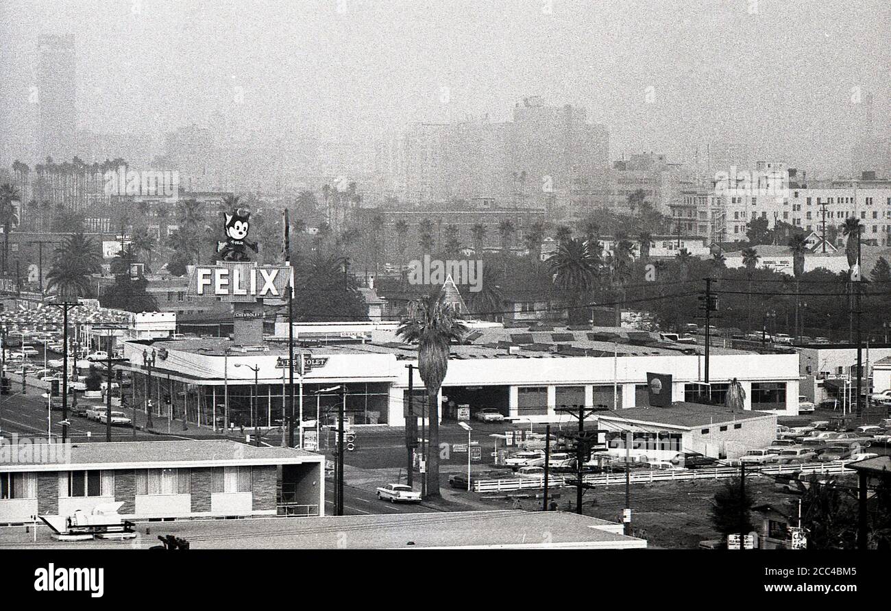 1964, historical, summertime and a view across a hazy Los Angles skyline, showing buildings, cars and 'Felix'. Stock Photo