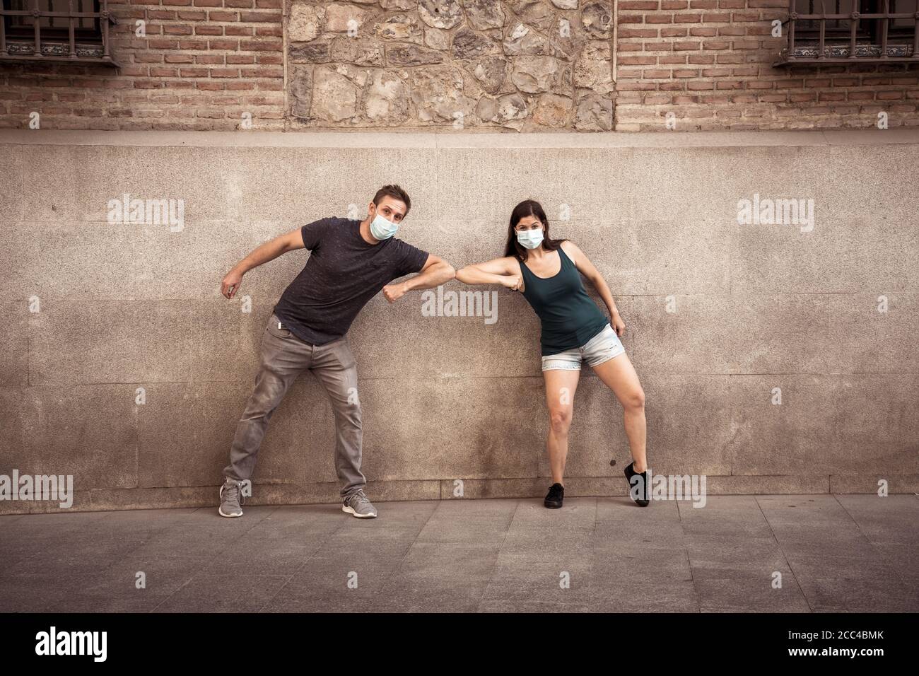 The New Normal and greeting style. Man and woman Shaking elbows or feet keeping social distancing to avoid Coronavirus spread. COVID-19 outbreak and d Stock Photo