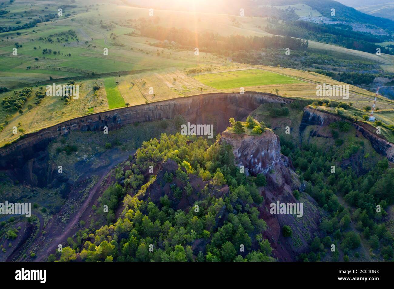 Vulcan Racos Aerial view of Racos volcanic crater in the sunrise, Brasov county ...