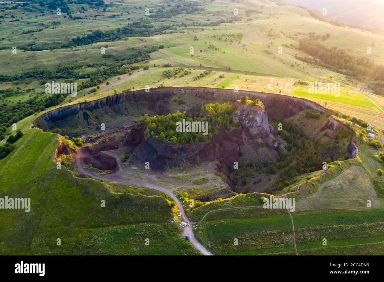 Vulcan Racos Aerial view of Racos volcanic crater in the sunrise, Brasov county ...