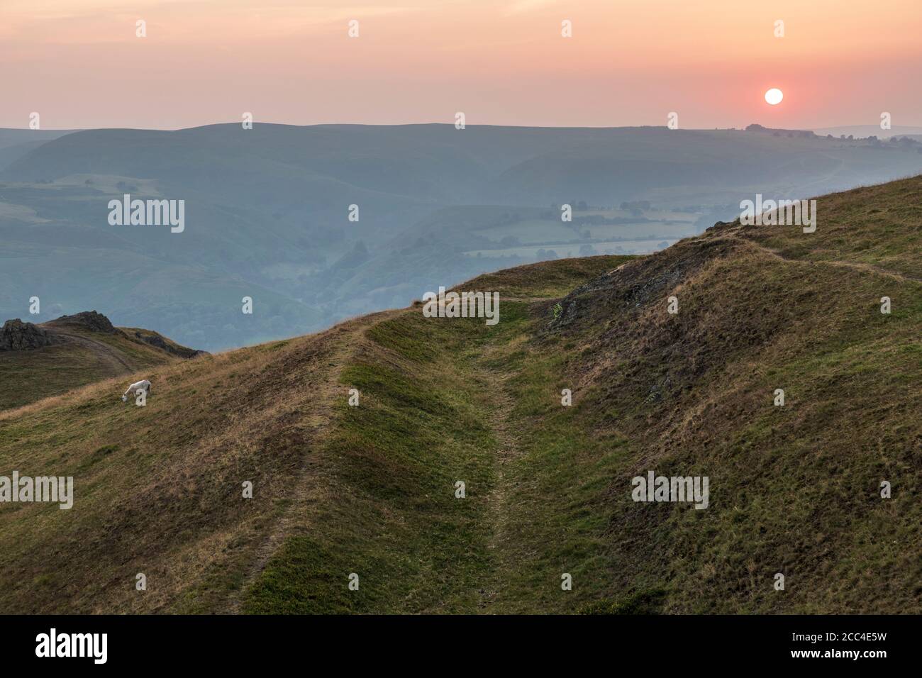 View along one of the defensive ditches of Caer Caradoc hillfort at sunset, Shropshire hills near Church Stretton Stock Photo