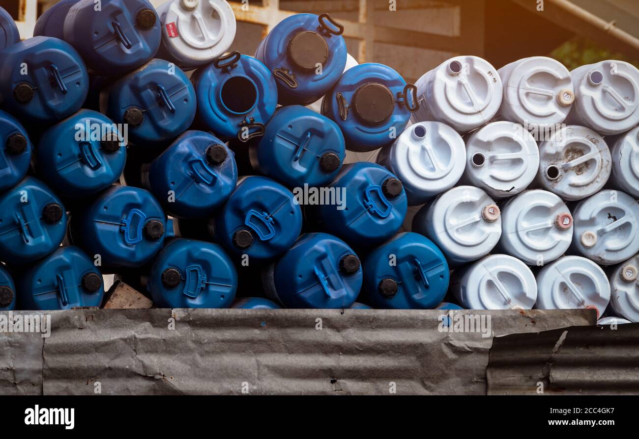 Selective focus on empty old chemical barrels. Blue and white oil drum