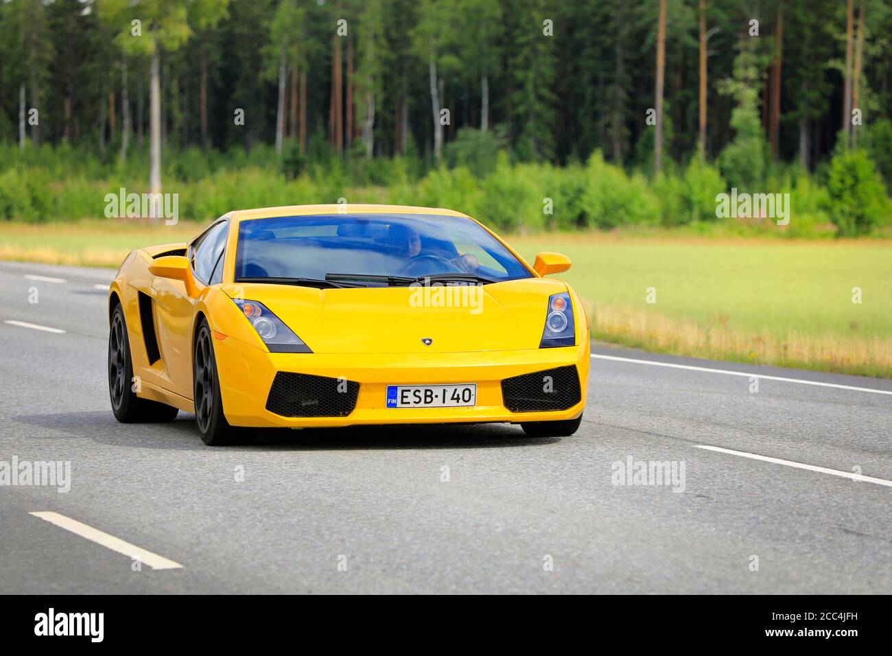 Yellow Lamborghini Gallardo 5.0 (V10) E-Gear 500Hp year 2003 at speed on Highway 10. Jokioinen, Finland. August 7, 2020. Stock Photo