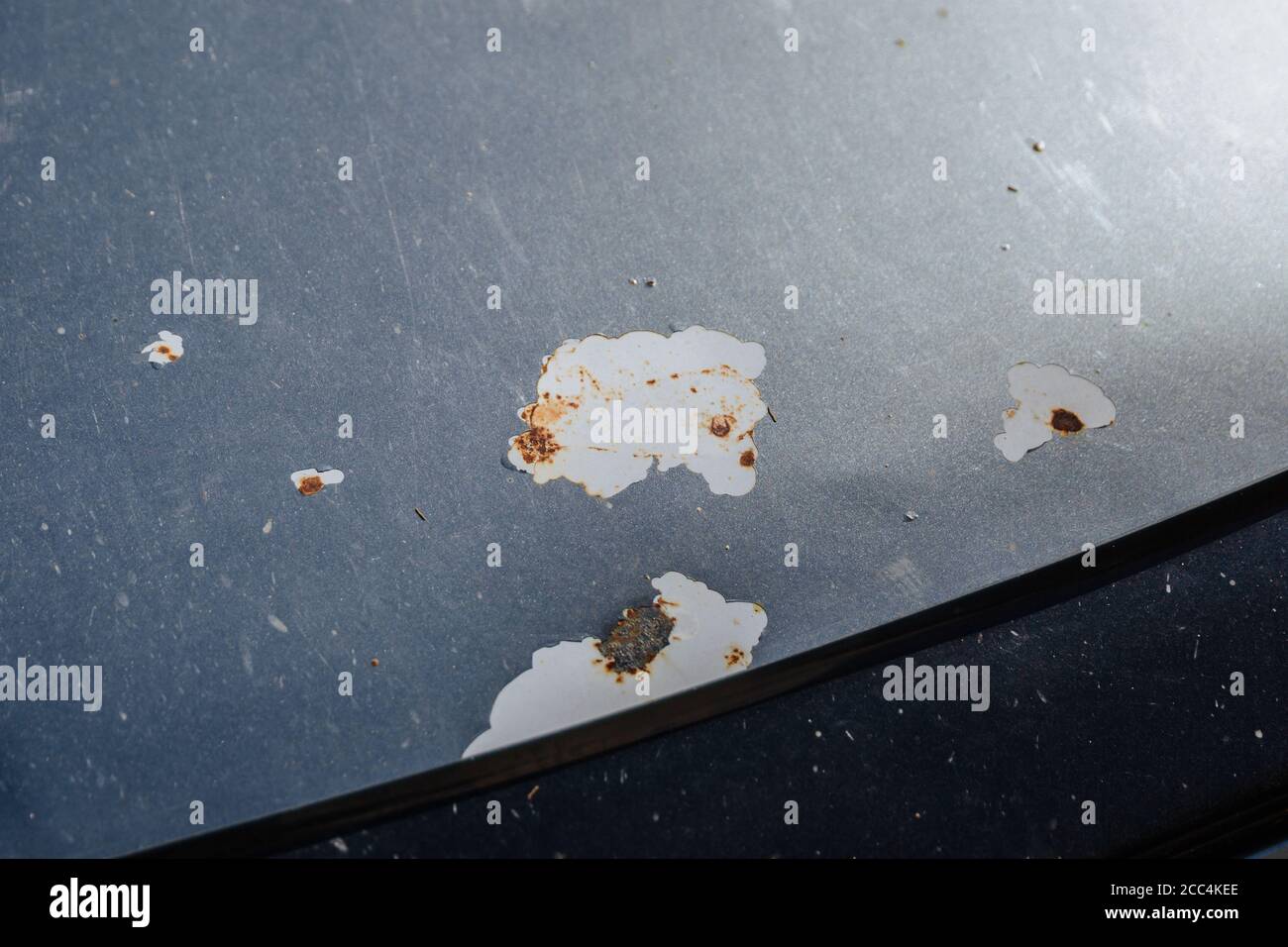 Car with damaged metal protective coating. A cleaned coat of paint that allows rust and