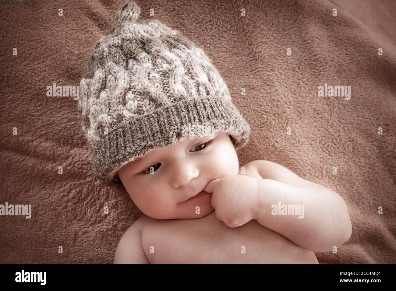 baby in hat on brown fur background Stock Photo
