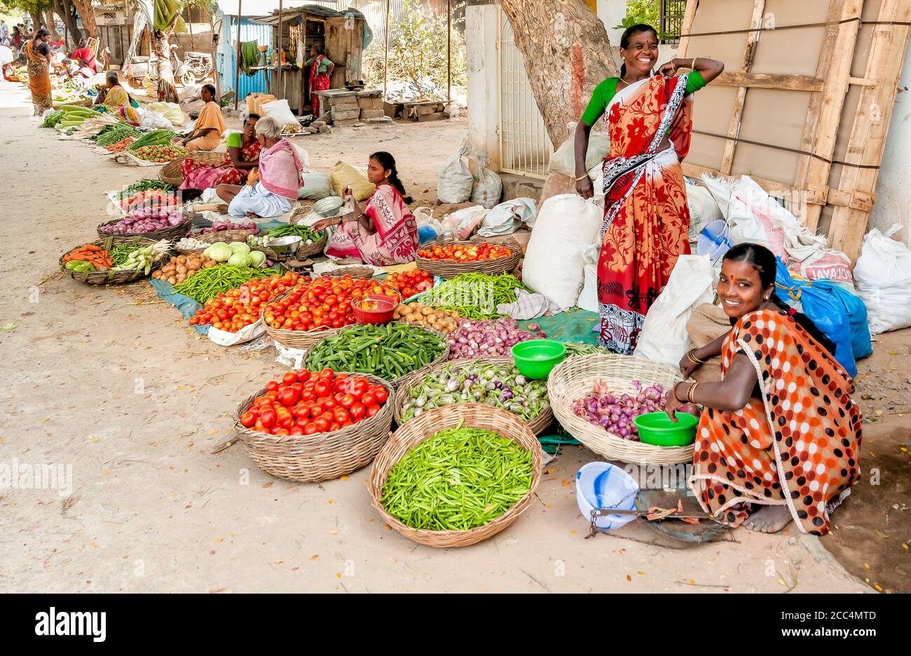 Puttaparthi, Andhra Pradesh, India - January 13, 2013: Indian women sell vegetables at street market of Puttaparthi. Stock Photo