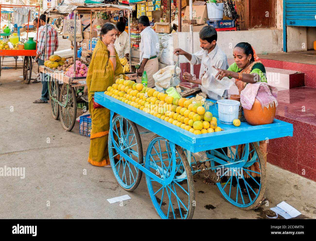 Puttaparthi, Andhra Pradesh, India - January 13, 2013: Street food vendors selling lemon juice in the Puttaparthi village. Stock Photo