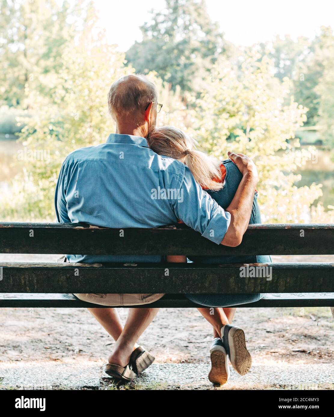 Senior couple hugging in park bench hi-res stock photography and images -  Alamy