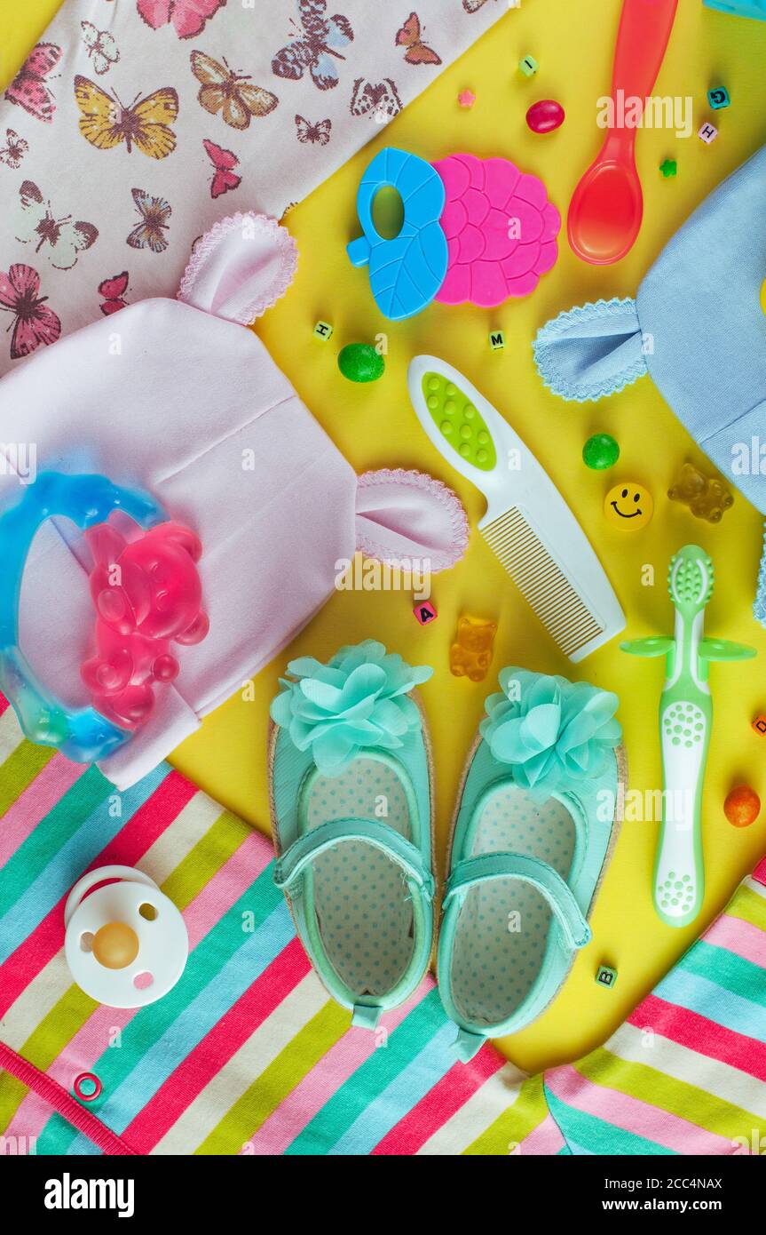 Baby clothes, accessories and candies on baby shower background Stock