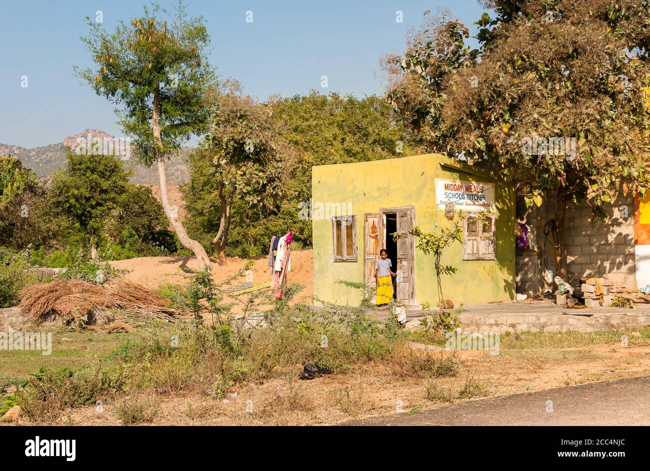 Puttaparthi, Andhra Pradesh, India - January 12, 2013: View of the midday meals school kitchen with Indian girl at the entrance in Puttaparthi, India Stock Photo