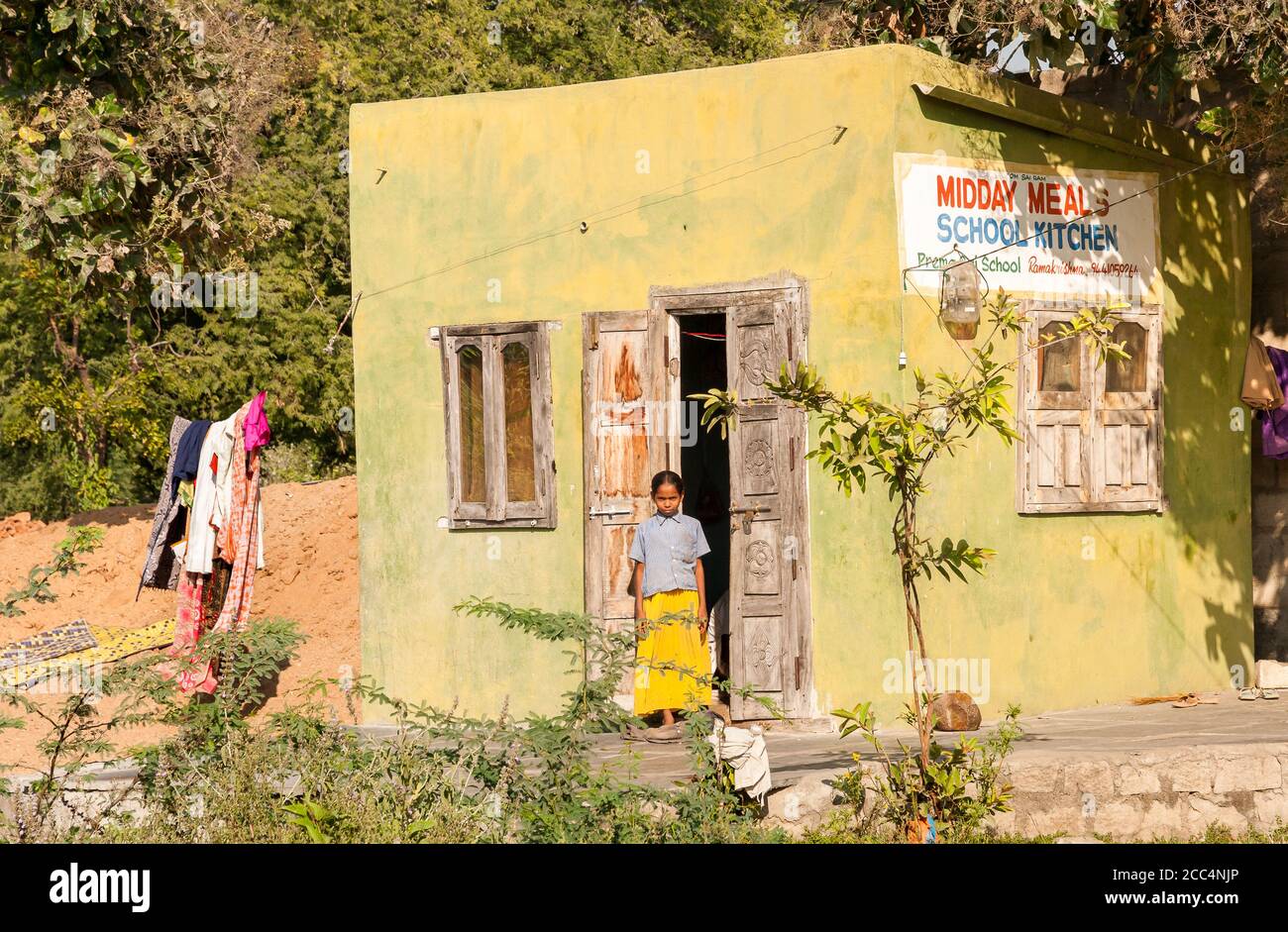 Puttaparthi, Andhra Pradesh, India - January 12, 2013: View of the midday meals school kitchen with Indian girl at the entrance in Puttaparthi, India Stock Photo