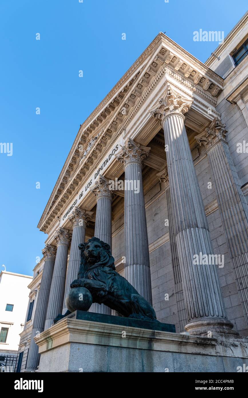Madrid, Spain - August 15, 2020: Low angle view of main entrance to Spanish Parliament with bronze statues of lions. Congress of Deputies Stock Photo