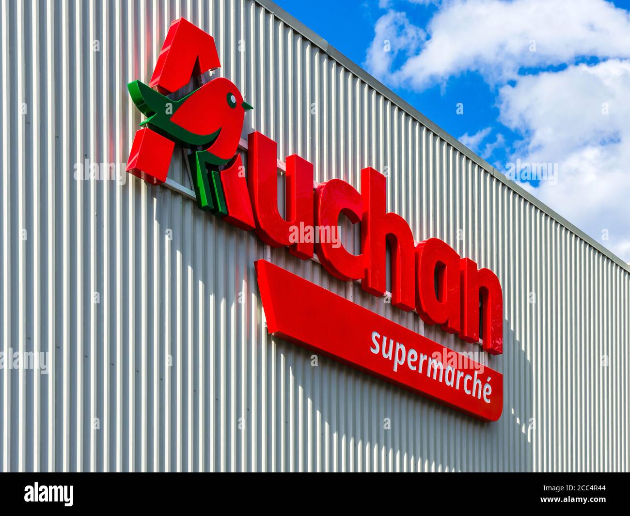 Auchan corporate logo on side of store - Ligueil, Indre-et-Loire, France. Stock Photo