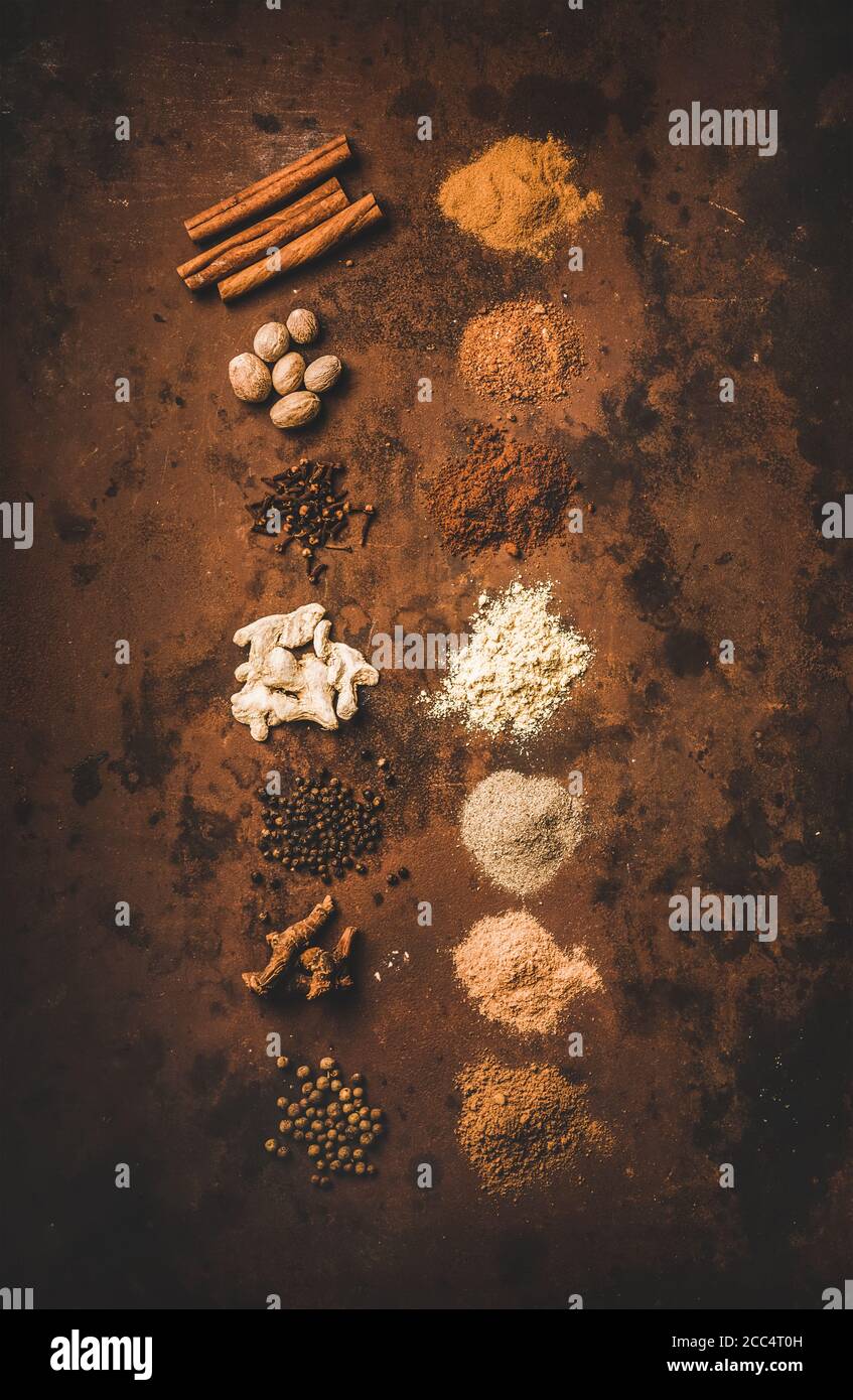 Turkish spice Yedi Bahar mix over rusty background Stock Photo