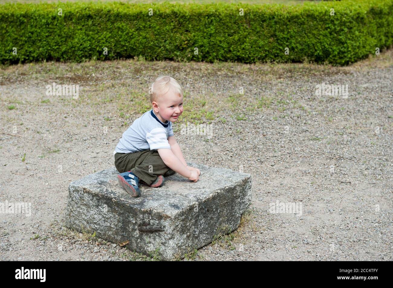 Two yeat old boy playing on a rock in Janowiec, Lublin Voivodeship, Poland Stock Photo