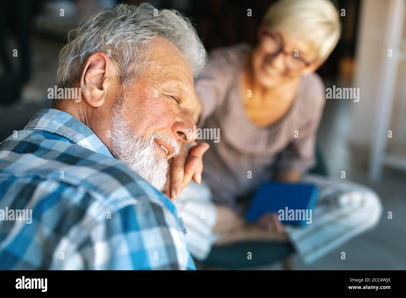 Happy senior couple relaxing at home together Stock Photo