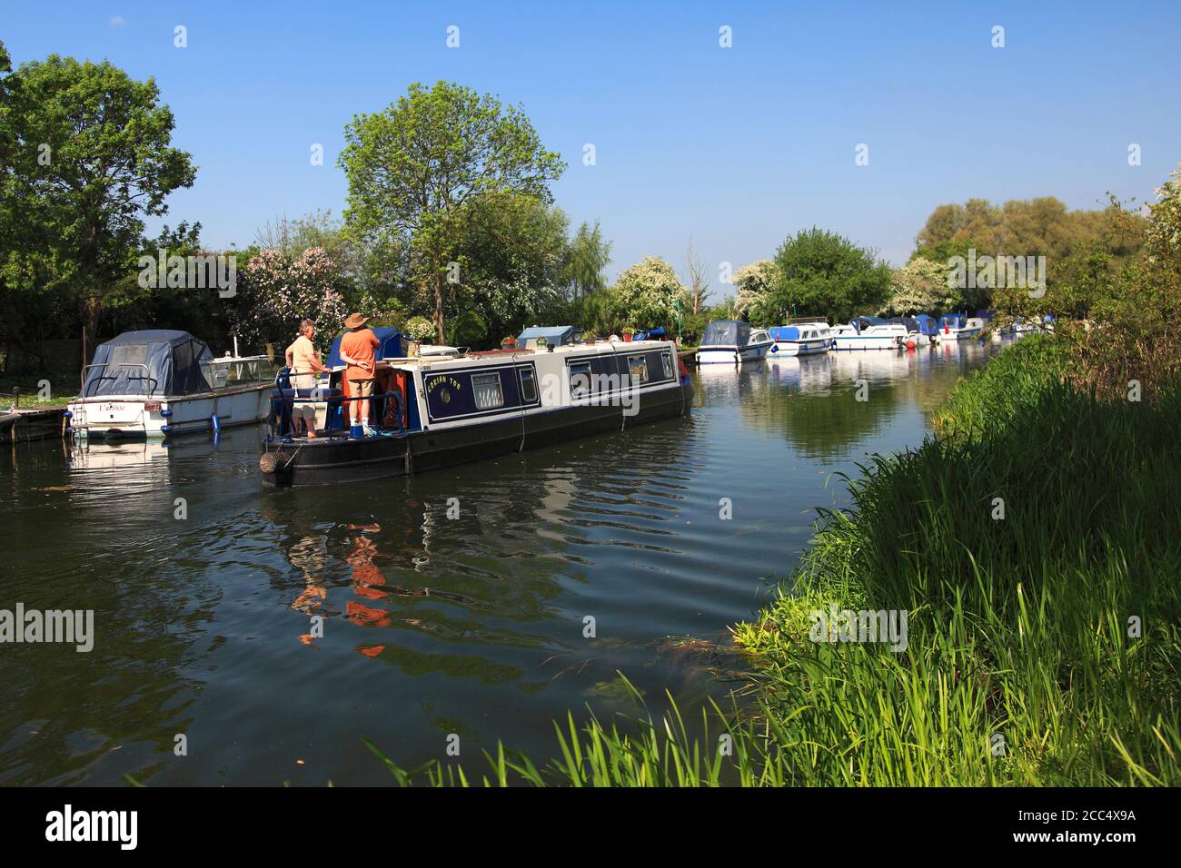 Narrowboats on the river Nene, near Castor village, Cambridgeshire County, England; UK Stock Photo