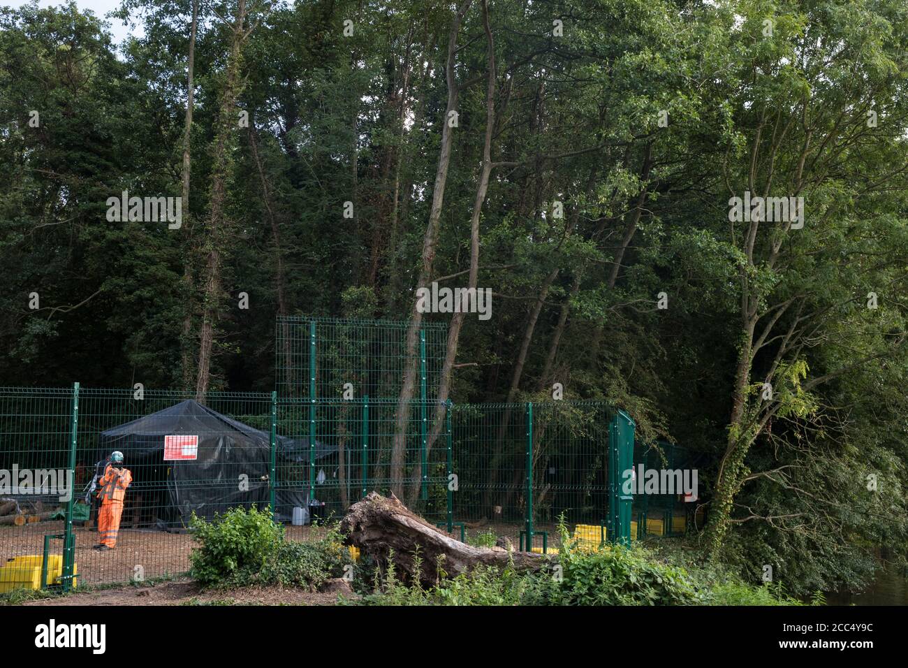 Denham, UK. 11th August, 2020. Fencing is pictured just after being moved forward by HS2 workers from a compound in which they are removing trees and vegetation to close a footpath alongside the river Colne used by environmental activists from HS2 Rebellion to access the Denham Protection Camp. The activists are protesting against work in the Colne Valley connected to the HS2 high-speed rail link. Credit: Mark Kerrison/Alamy Live News Stock Photo