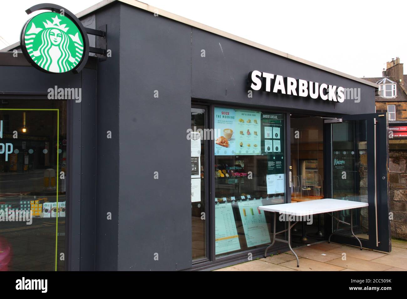Table and Door Open Outside a Branch of Starbucks During Scottish Coronavirus Lockdown Easing Stock Photo