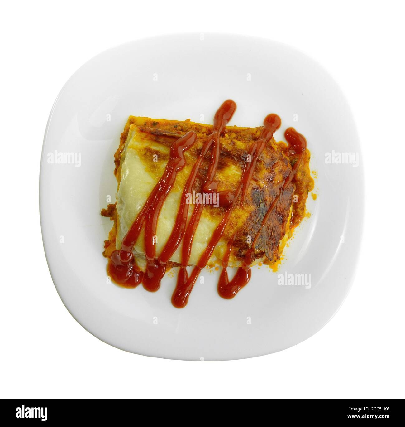 Portion of tasty lasagna. An isolated traditional lasagna made with minced beef bolognaise sauce. Tasty serving of traditional Italian lasagne with sp Stock Photo