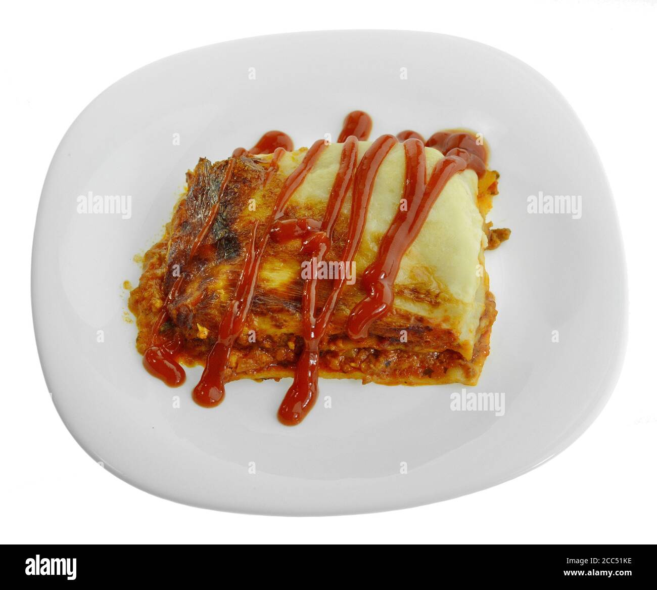 Portion of tasty lasagna. An isolated traditional lasagna made with minced beef bolognaise sauce. Tasty serving of traditional Italian lasagne with sp Stock Photo