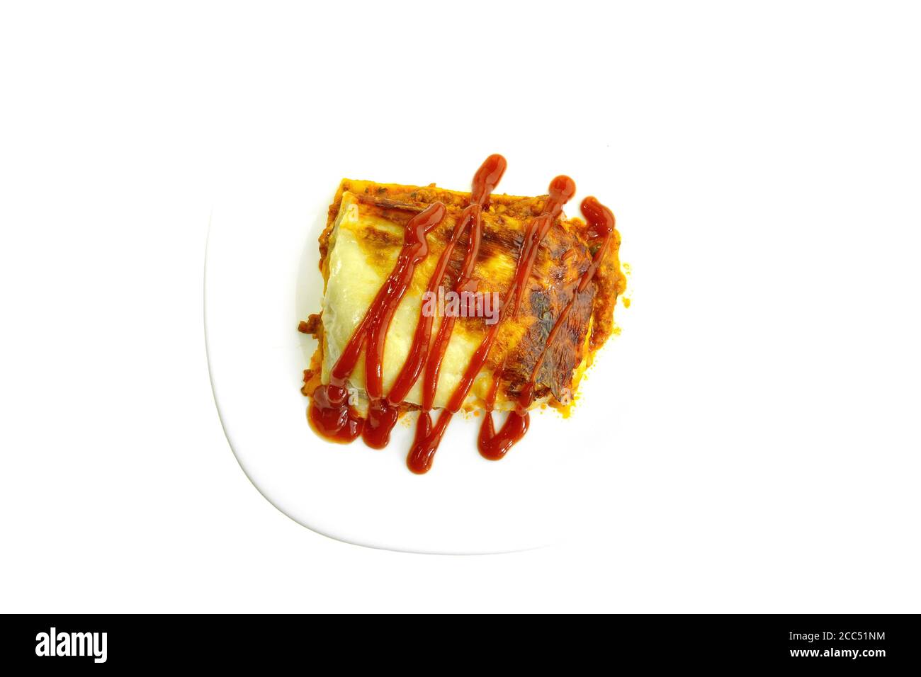 Portion of tasty lasagna. An isolated traditional lasagna made with minced beef bolognaise sauce. Tasty serving of traditional Italian lasagne with sp Stock Photo