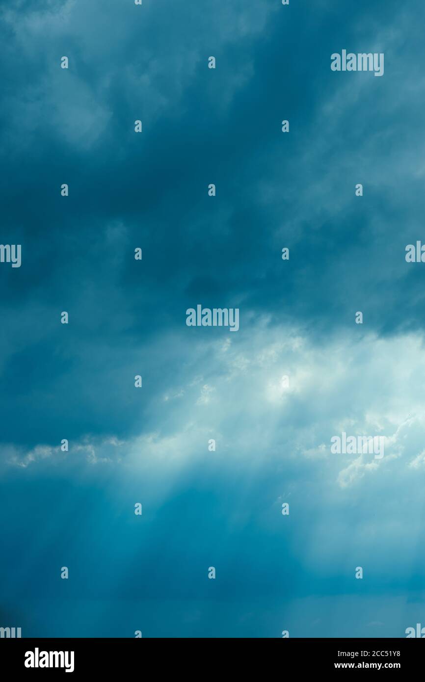 Sunrays Through Blue Rainy Dramatic Sky. Natural Abstract Background Stock Photo