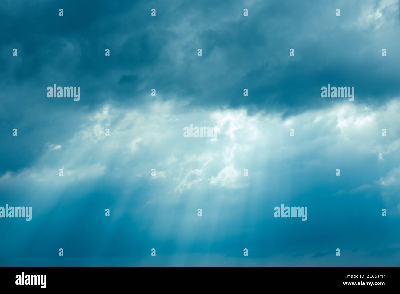 Sunrays Through Blue Rainy Dramatic Sky. Natural Abstract Background Stock Photo