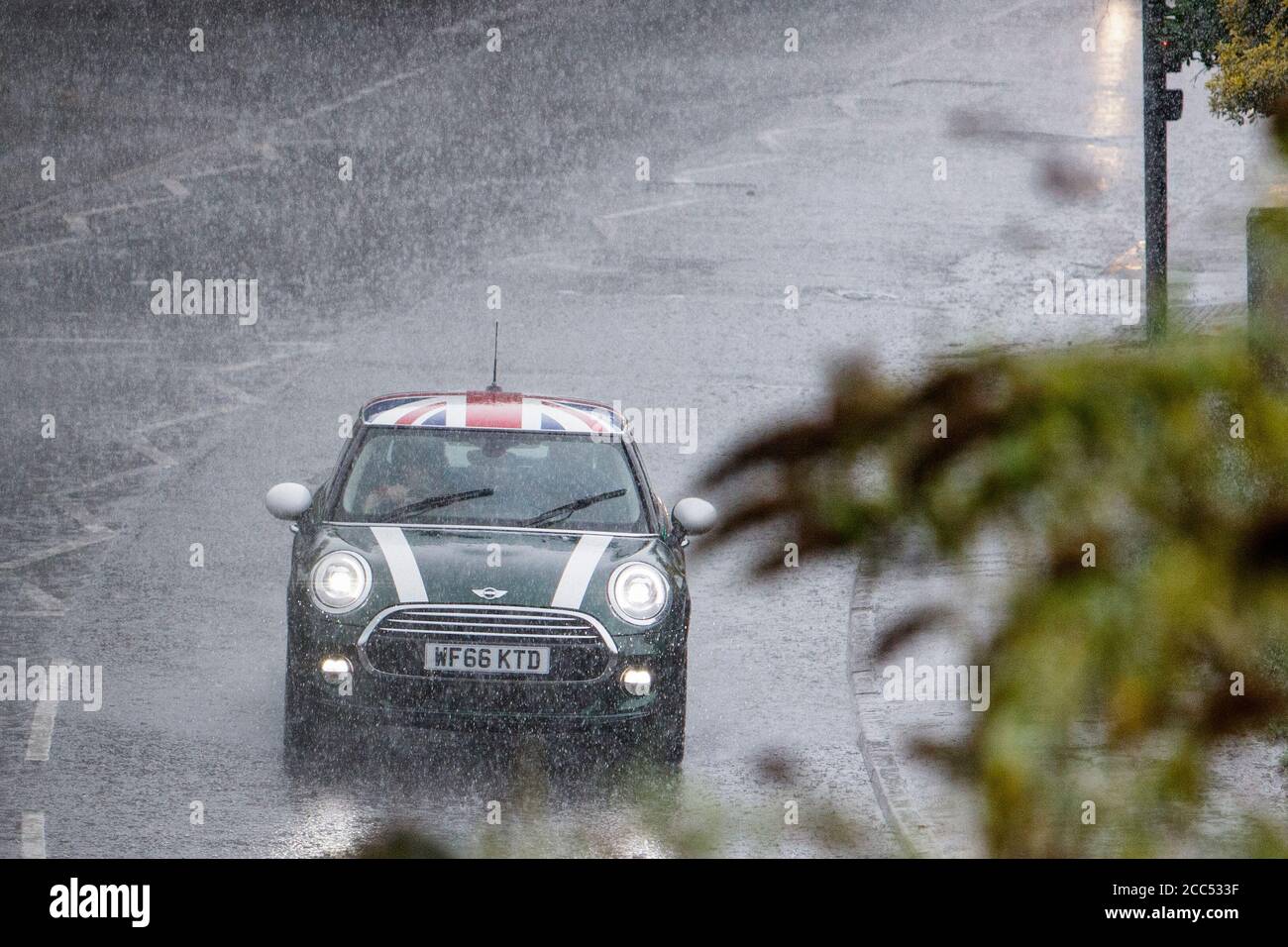 Chippenham, Wiltshire, UK. 18th August, 2020. As forecasters warn that thunder storms will affect many parts of the UK, drivers are pictured braving heavy rain in Chippenham. Credit: Lynchpics/Alamy Live News Stock Photo