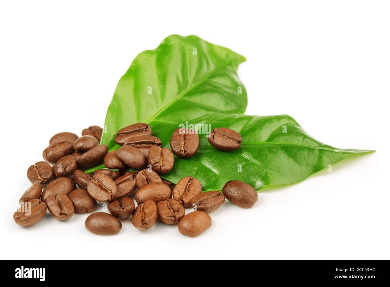 roasted coffee beans and green leaves isolated Stock Photo Alamy