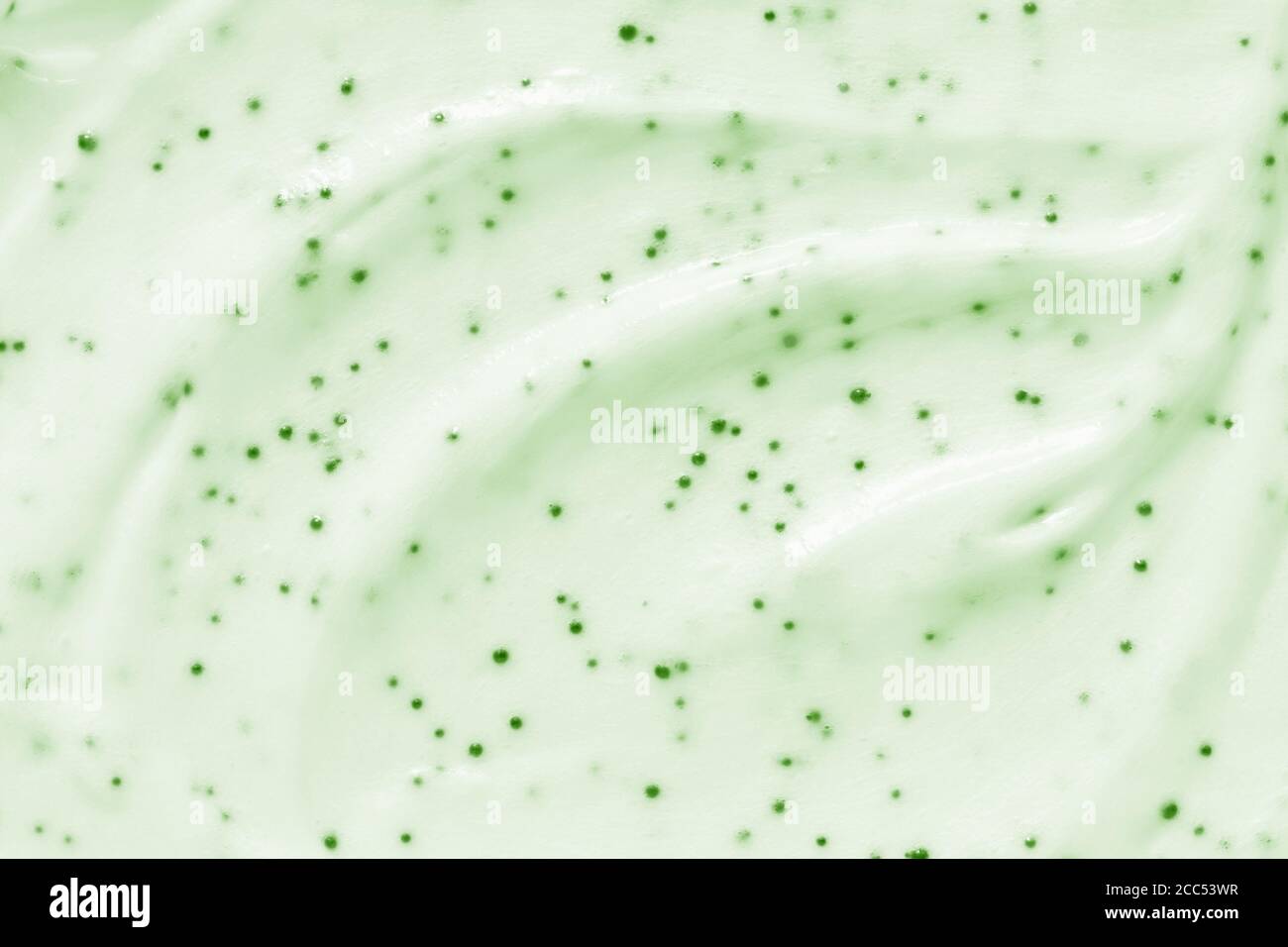 Face cream scrub texture background. Green color exfoliating skincare