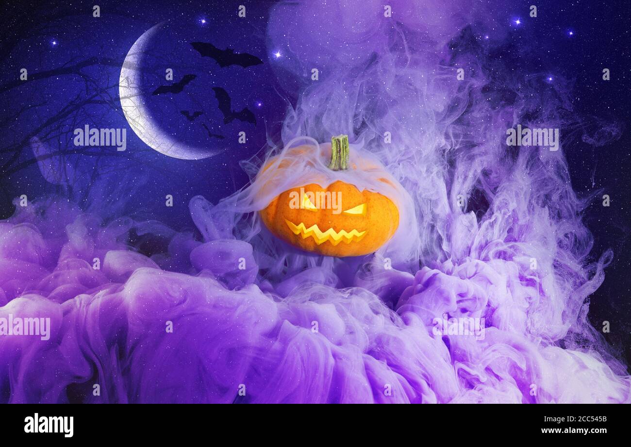 glowing halloween pumpkin in a purple fog Stock Photo