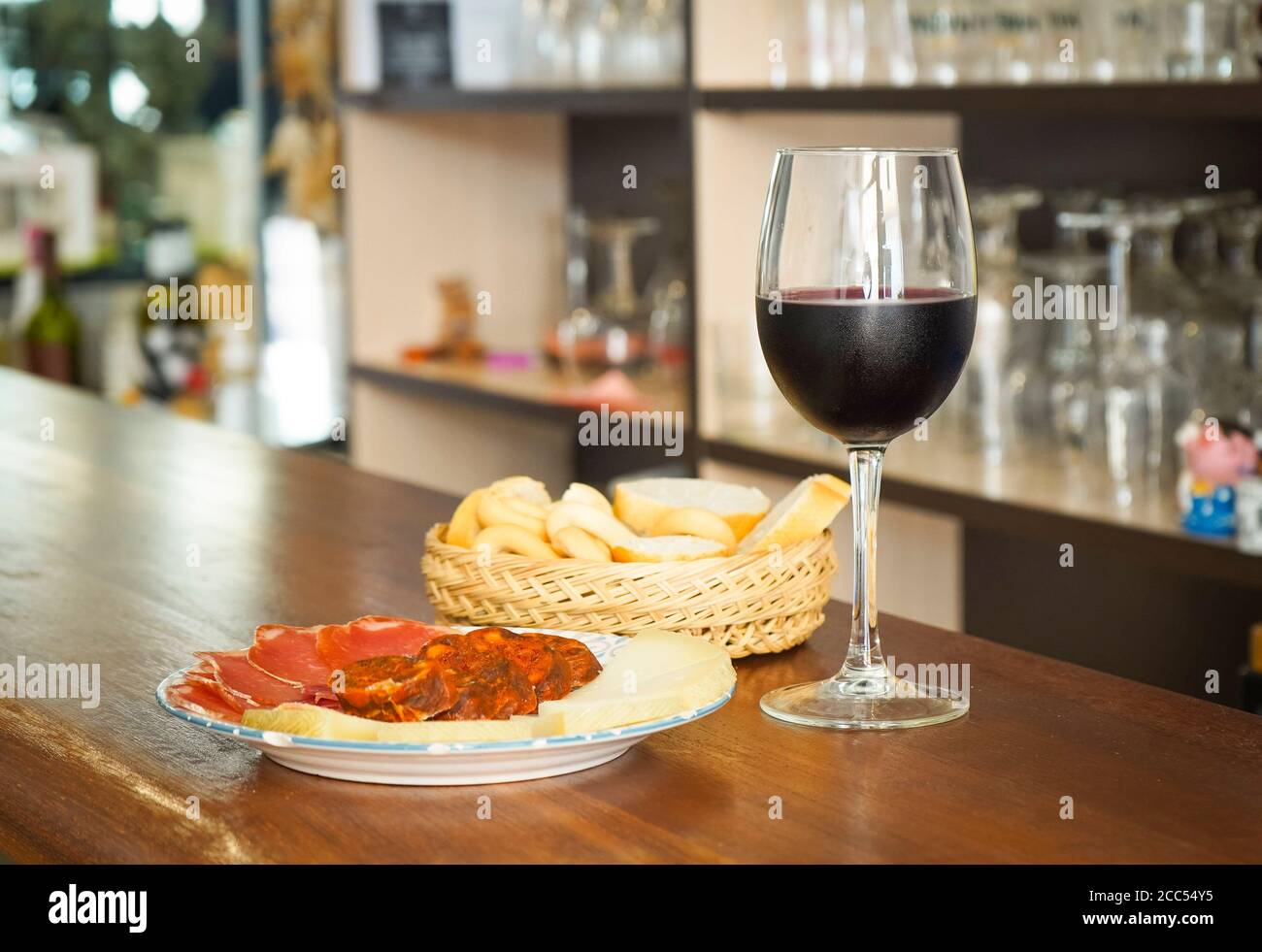 Spanish tapas Manchego cheese, Ham, Chorizo, with glass of red wine and