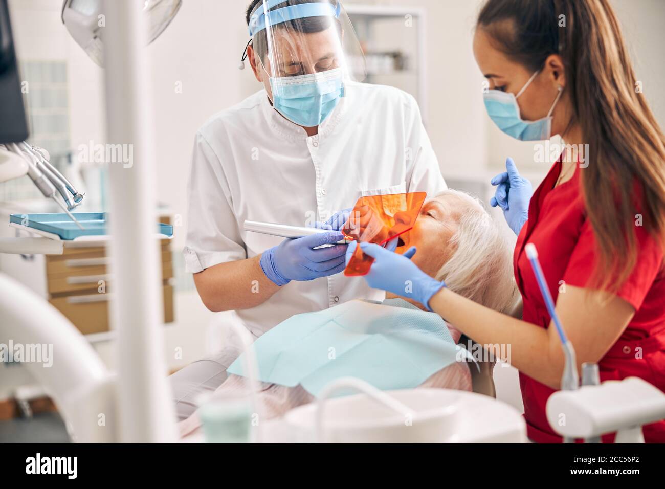 Nurse using dental ultraviolet curing light for filling polymerization Stock Photo Alamy