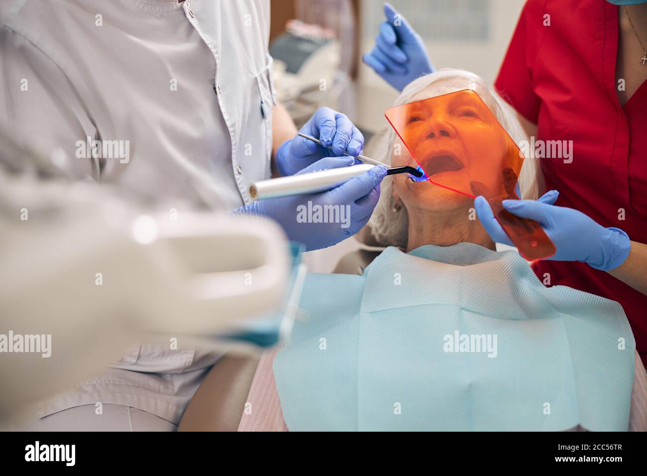 Woman patient with dental curing light on the dentist chair Stock Photo
