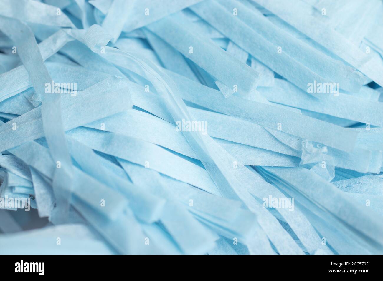 Blue shredded paper pieces texture background. Web design backdrop Stock Photo