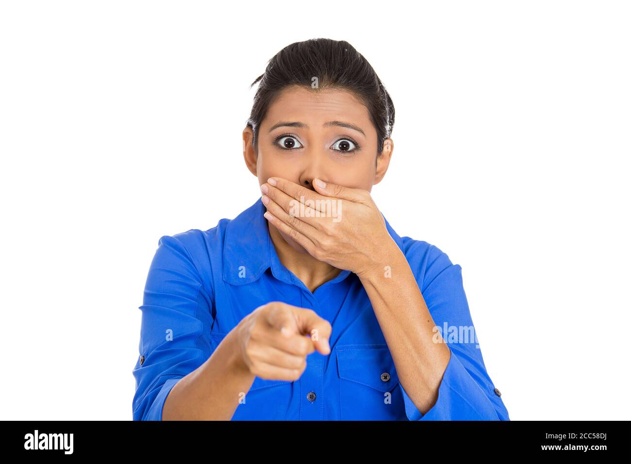 Closeup portrait of a young woman pointing with index finger stunned dumbstruck dumbfounded looking at camera isolated on white background. Positive e Stock Photo