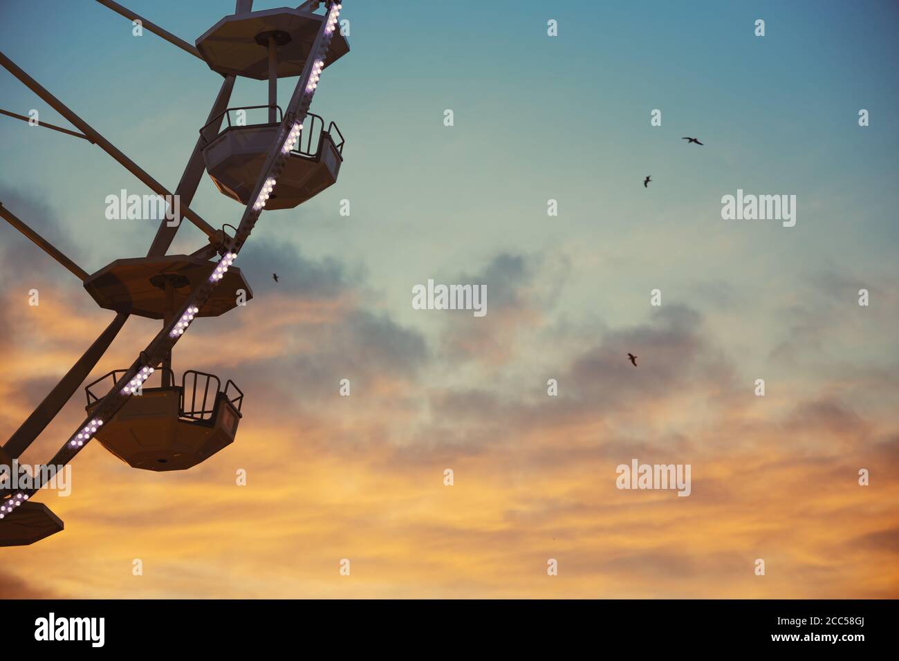 Ferris Wheel with sunset sky and clouds Stock Photo - Alamy