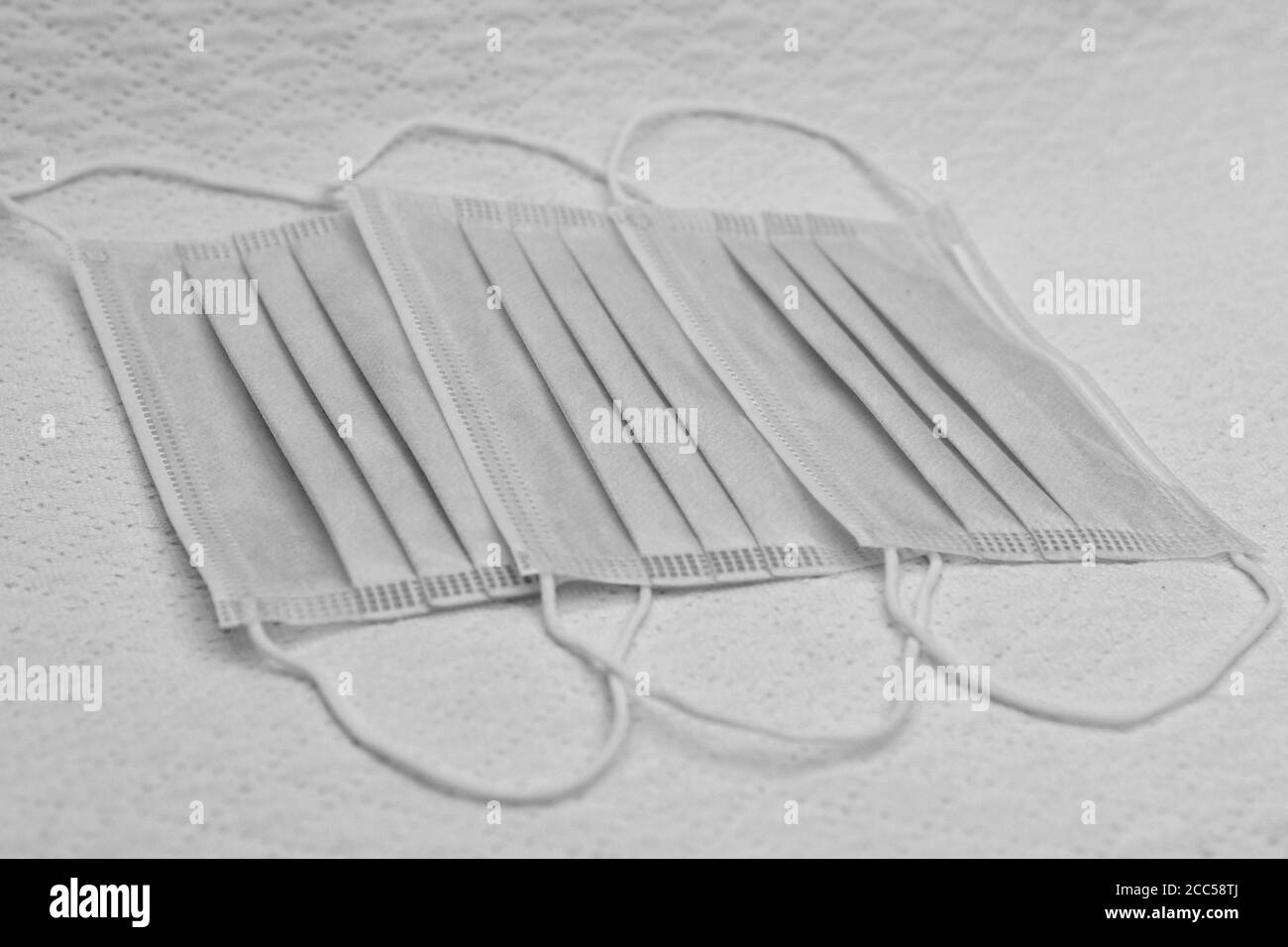 Three disposable surgical masks, black and white Stock Photo - Alamy