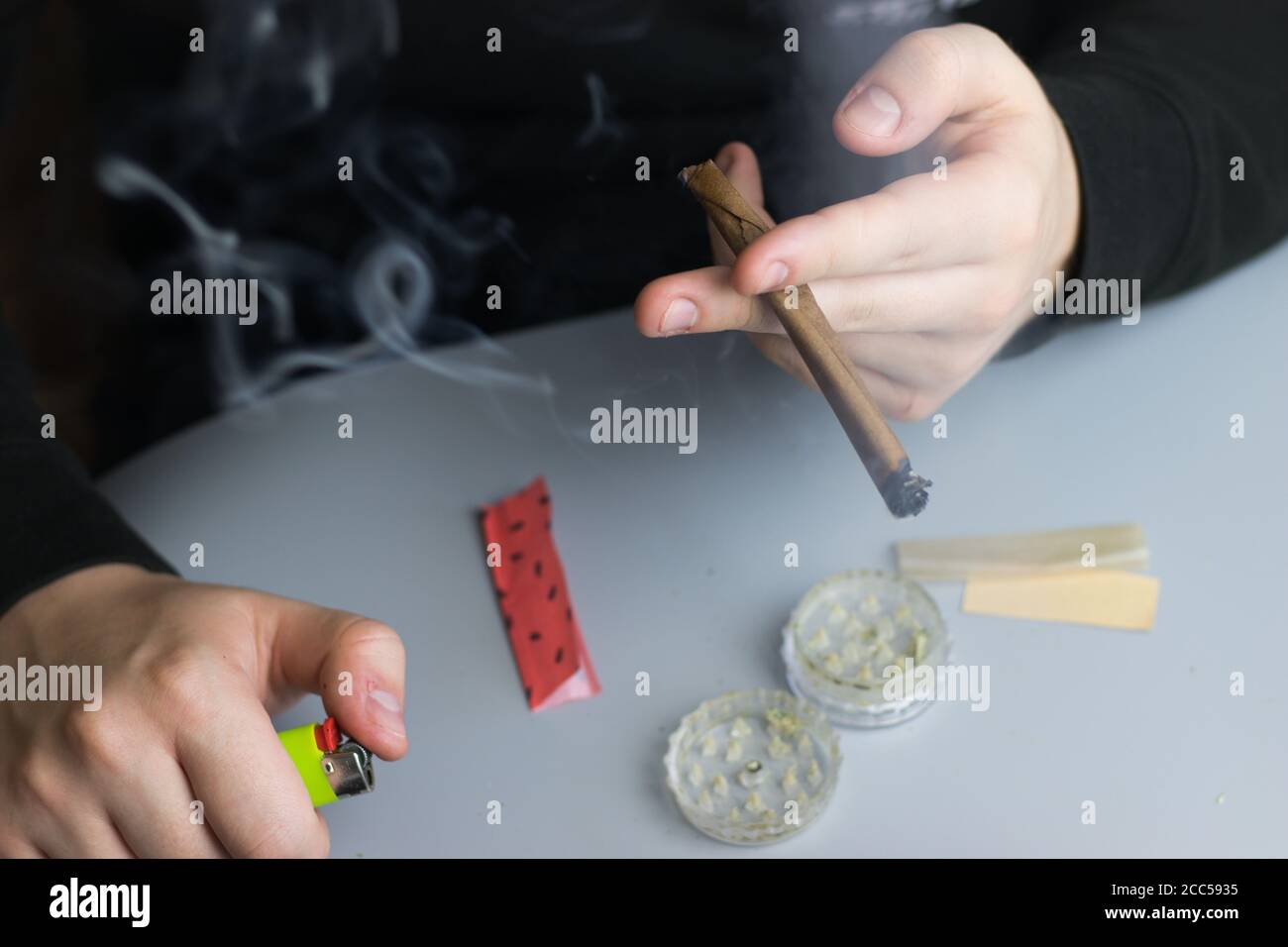 Smoking cannabis in blunt paper, marijuana recreational use Stock Photo