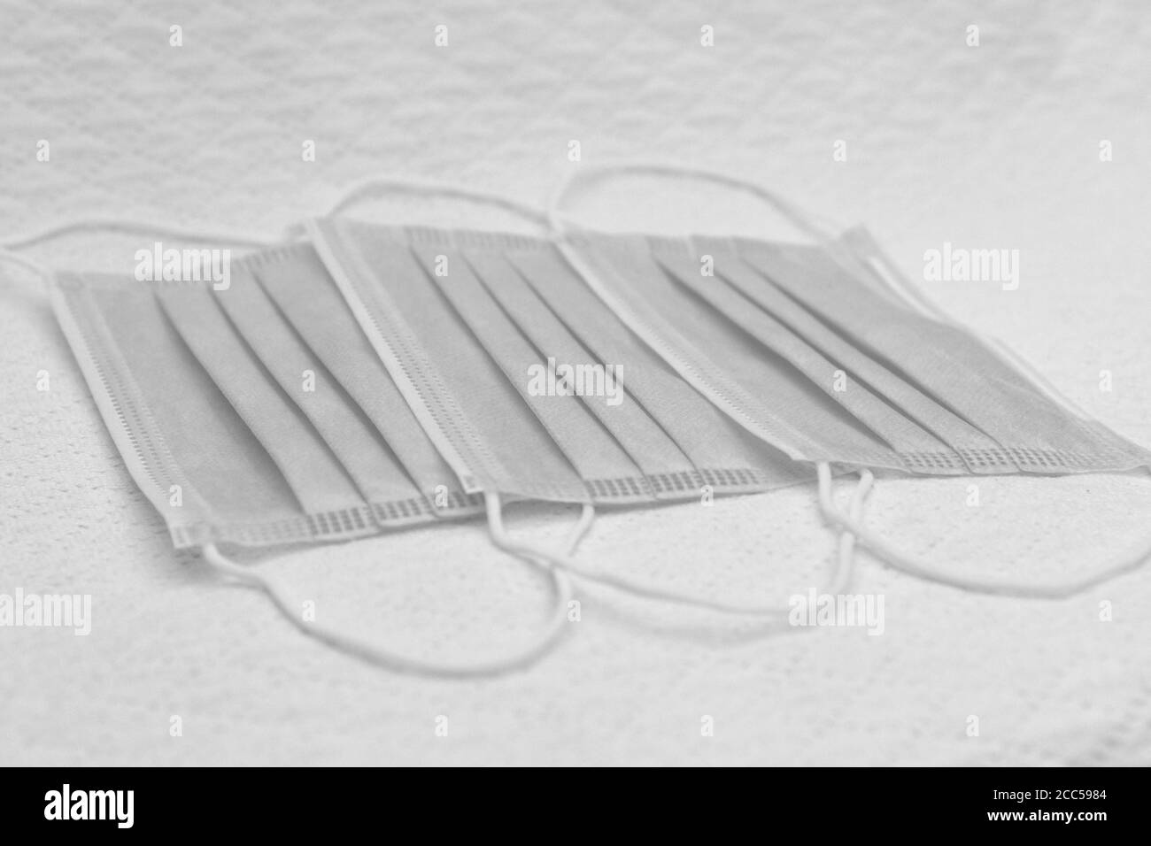 Three disposable surgical masks, black and white Stock Photo - Alamy