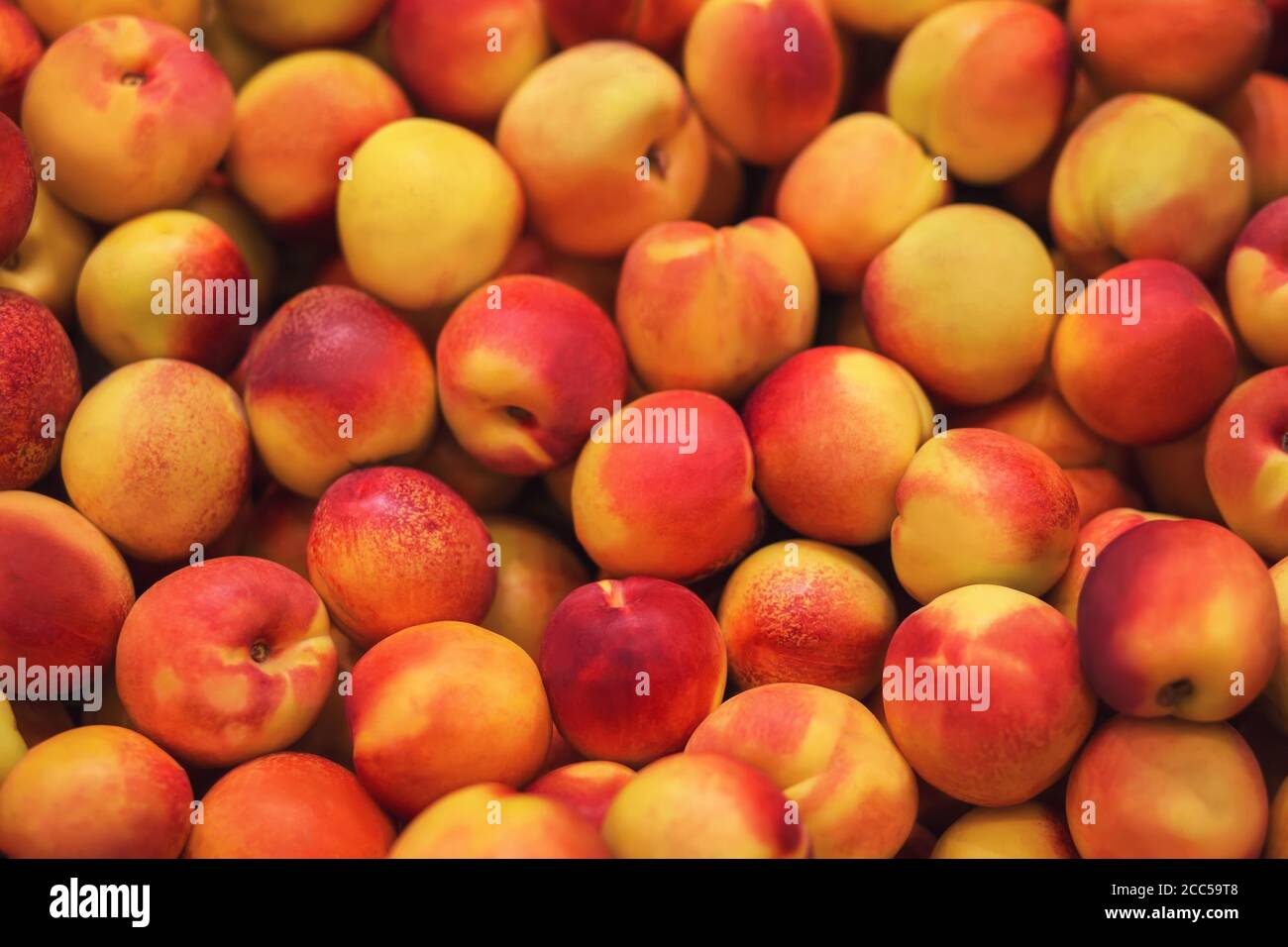 A background depicting many bright, ripe, delicious nectarine fruits