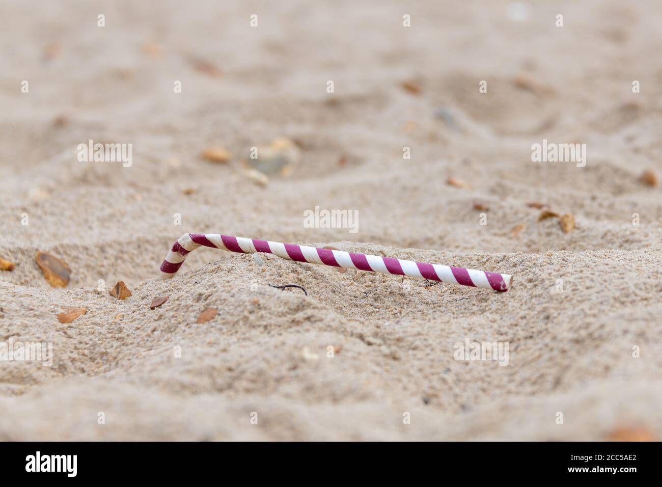 Plastic Pollution: Dropped straw. Bournemouth, UK. Stock Photo