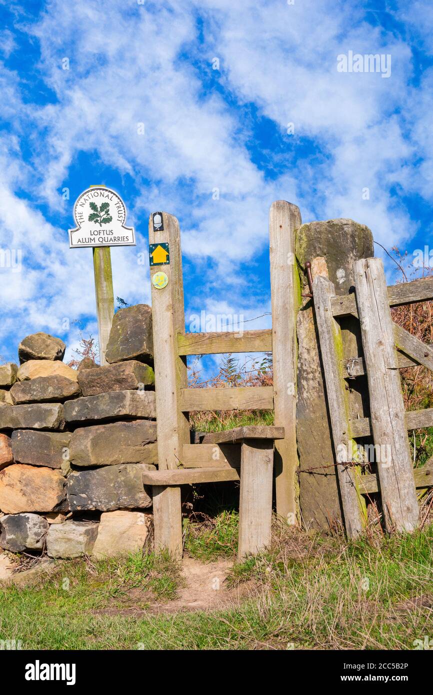 Stile on The Cleveland Way coastal path above Loftus Alum quarries (name on sign) between Staithes and Skinningrove, North Yorkshire, England. UK Stock Photo